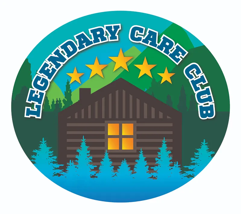 Legendary Care Club circular badge logo featuring dark brown log cabin with illuminated yellow windows, five gold stars arc above cabin, green mountain landscape background, turquoise pine trees in foreground, LEGENDARY CARE CLUB text in bold white letters with navy blue fill arched around top, gradient turquoise to blue background, outdoor mountain lodge aesthetic for HVAC maintenance agreement program branding emphasizing five-star premium service, reliability, and home comfort