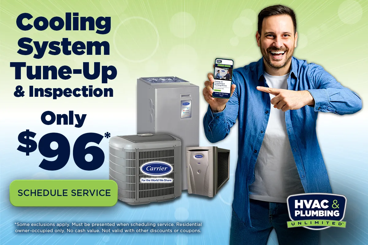 Cooling System Tune-Up and Inspection promotional banner featuring green teal gradient background, Only $96 pricing, smiling man in blue denim shirt pointing at phone showing HVAC service app, Carrier AC units and furnace equipment with For the World We Share tagline, green Schedule Service CTA button, disclaimer text about exclusions and residential owner-occupied requirements